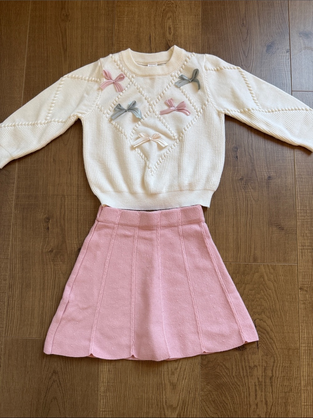 Cream Bow-Appliqué Knit Sweater with Pink Accent and Matching Pink Skirt